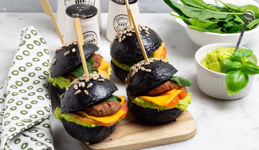 Black burger al carbone con pomodori e hummus di edamame